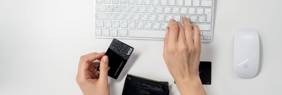 E-commerce setup featuring a keyboard, card, and wallet, ideal for online shopping concepts.